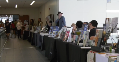 a row of authors and book sellers at the COC Book Fair.